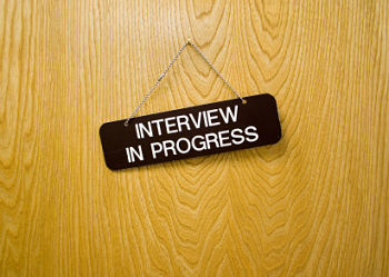 Door with interview sign hanging from it.