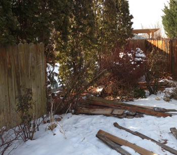 A fence blown down in the wind.