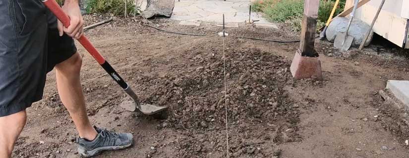digging patio with shovel