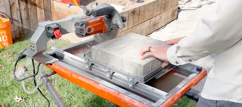wet tile saw cutting concrete pavers