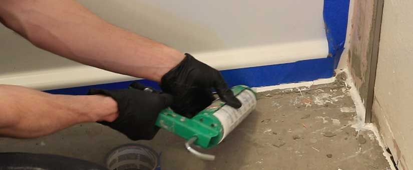 Caulk front of tub